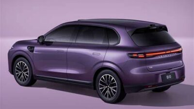 Rear-left three-quarter view of a purple SUV with sleek LED tail lights on a lavender backgroundeni, showing a modern family vehicle.